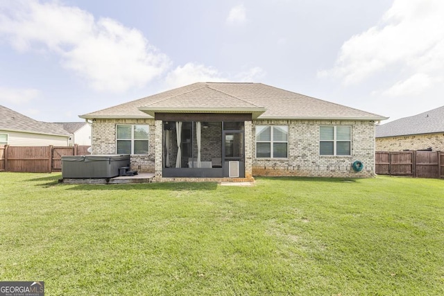 213 Barnyard Way, Perry, GA 31069 - rear view of house featuring a hot tub, a sunroom, brick siding, and a shingled roof