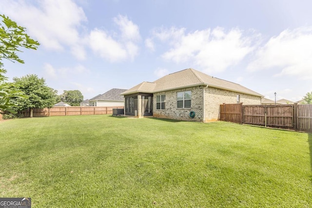 213 Barnyard Way, Perry, GA 31069 - rear view of house featuring a sunroom, brick siding, and roof with shingles