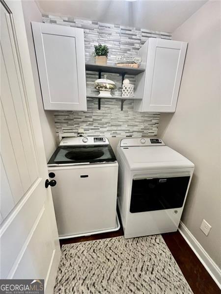 37 Frost, Dawsonville, GA 30534 - washroom with cabinet space, washing machine and clothes dryer, baseboards, and dark wood-style flooring