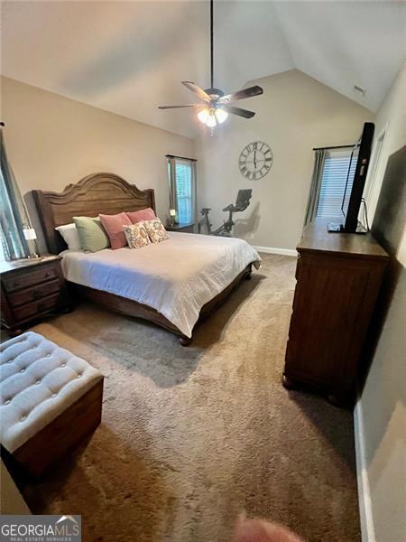 37 Frost, Dawsonville, GA 30534 - bedroom featuring vaulted ceiling, carpet flooring, a ceiling fan, and baseboards