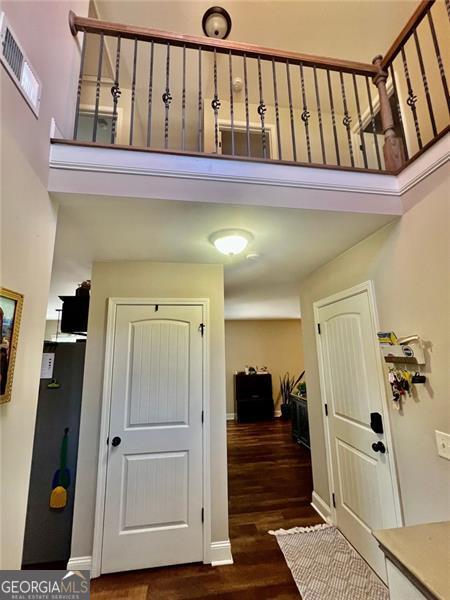 37 Frost Ln, Dawsonville, GA 30534 - foyer entrance with dark wood-type flooring, a high ceiling, and baseboards