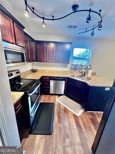 37 Frost Ln, Dawsonville, GA 30534 - kitchen with stainless steel appliances, a sink, rail lighting, and light wood-style floors