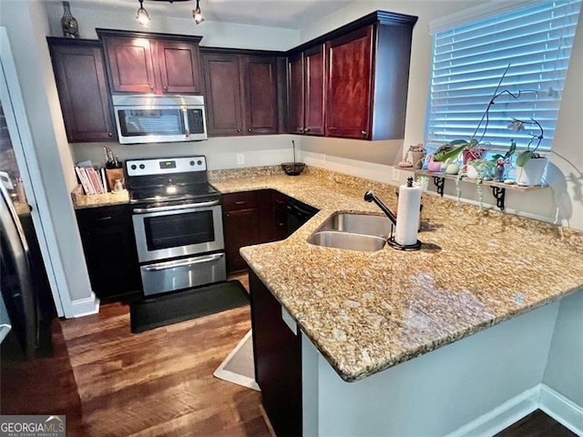 37 Frost, Dawsonville, GA 30534 - kitchen featuring appliances with stainless steel finishes, a sink, dark wood-style floors, light stone countertops, and a peninsula
