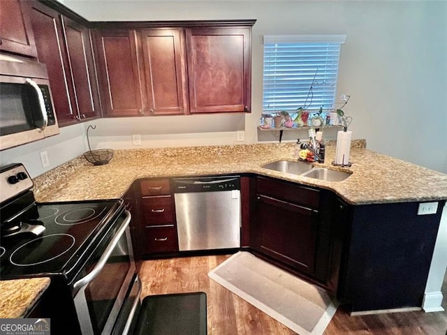 37 Frost Ln, Dawsonville, GA 30534 - kitchen with appliances with stainless steel finishes, light wood finished floors, a peninsula, and a sink