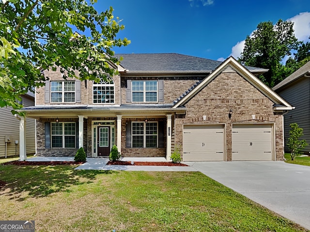 3507 Hideaway Ln, Loganville, GA 30052 - view of front facade with driveway, a garage, a front yard, and brick siding