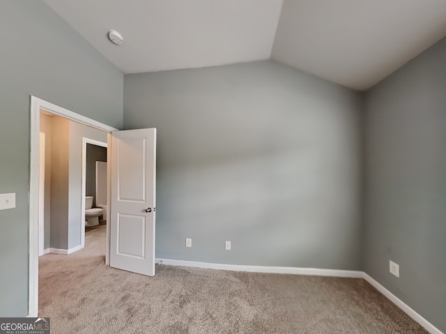 3507 Hideaway Ln, Loganville, GA 30052 - unfurnished bedroom with carpet floors, lofted ceiling, and baseboards