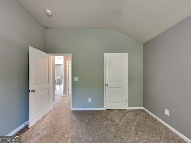3507 Hideaway Ln, Loganville, GA 30052 - unfurnished bedroom featuring vaulted ceiling, carpet floors, and baseboards