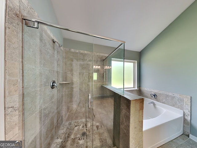 3507 Hideaway Ln, Loganville, GA 30052 - bathroom with a bath, a stall shower, and vaulted ceiling