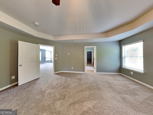 3507 Hideaway Ln, Loganville, GA 30052 - carpeted spare room featuring baseboards, a tray ceiling, a smoke detector, and ceiling fan