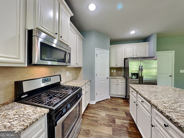 3507 Hideaway Ln, Loganville, GA 30052 - kitchen featuring stainless steel appliances, dark wood-type flooring, white cabinets, recessed lighting, and decorative backsplash