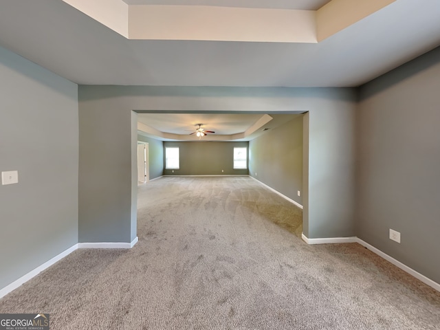 3507 Hideaway Ln, Loganville, GA 30052 - spare room featuring carpet floors, a ceiling fan, baseboards, and a raised ceiling