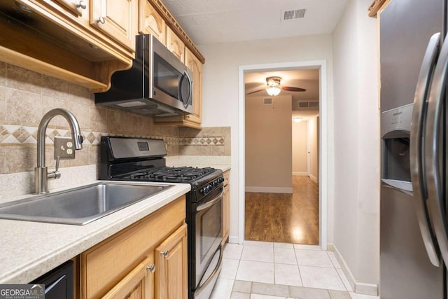 408 River Run Dr, Sandy Springs, GA 30350 - kitchen featuring appliances with stainless steel finishes, a sink, light countertops, and decorative backsplash