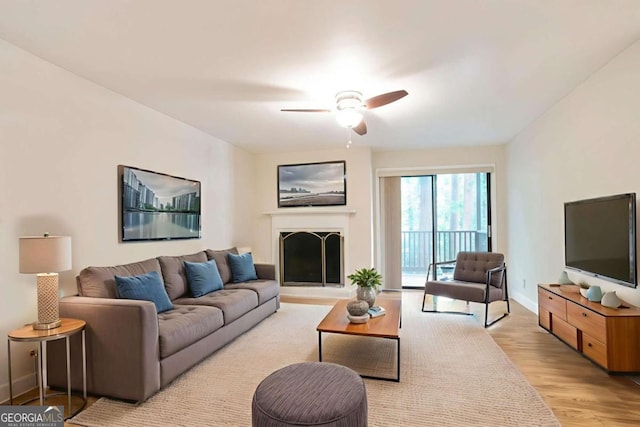 408 River Run Dr, Sandy Springs, GA 30350 - living area featuring ceiling fan, light wood-type flooring, baseboards, and a fireplace with raised hearth