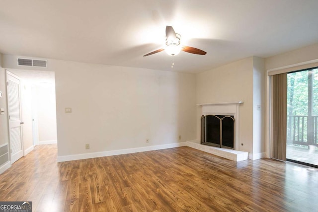 408 River Run Dr, Sandy Springs, GA 30350 - unfurnished living room with ceiling fan, wood finished floors, a brick fireplace, and baseboards