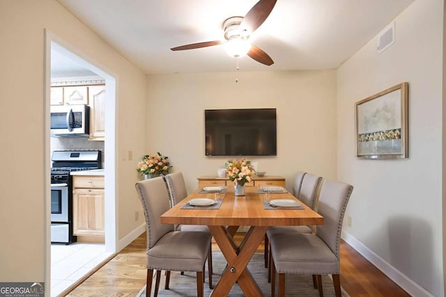 408 River Run Dr, Sandy Springs, GA 30350 - dining room featuring a ceiling fan, light wood-style floors, and baseboards