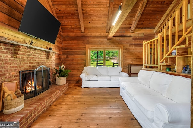 121 Samples Rd, Forsyth, GA 31029 - living room with wooden ceiling, hardwood / wood-style flooring, a brick fireplace, and wood walls