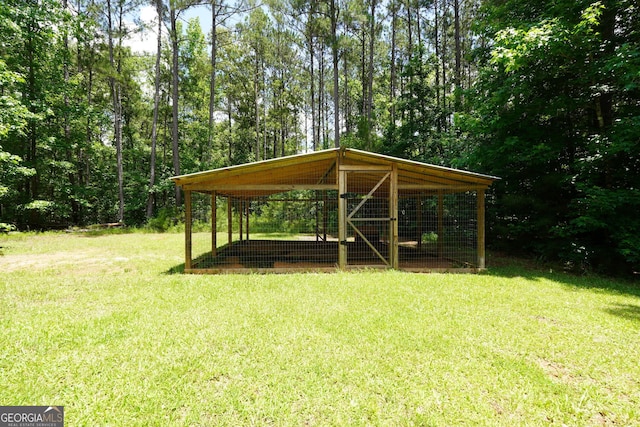 121 Samples Rd, Forsyth, GA 31029 - view of green lawn featuring exterior structure, an outbuilding, and a carport