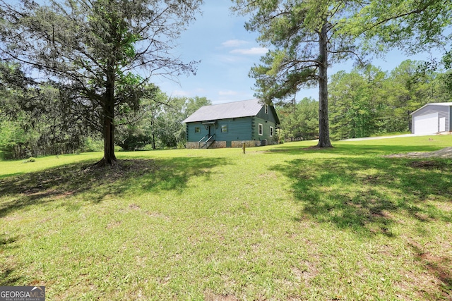 121 Samples Rd, Forsyth, GA 31029 - view of green lawn with a garage