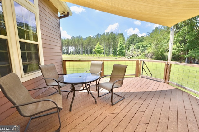 2025 Chicken Rd, Dudley, GA 31022 - deck featuring outdoor dining space and a wooded view