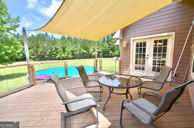 2025 Chicken Rd, Dudley, GA 31022 - wooden deck with french doors, a yard, outdoor dining area, and an outdoor pool