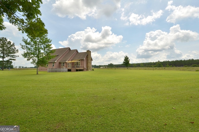 2025 Chicken Rd, Dudley, GA 31022 - view of green lawn with a deck