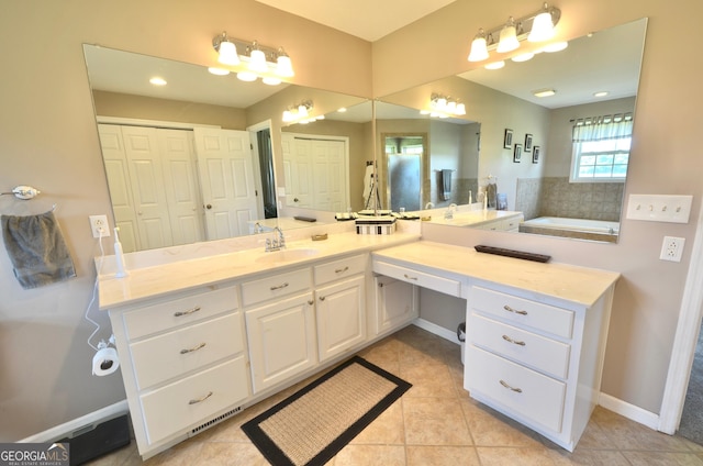 2025 Chicken Rd, Dudley, GA 31022 - bathroom with vanity, a garden tub, tile patterned flooring, and a closet