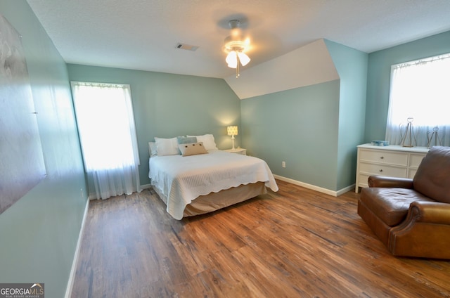 2025 Chicken Rd, Dudley, GA 31022 - bedroom featuring wood finished floors, multiple windows, vaulted ceiling, and ceiling fan