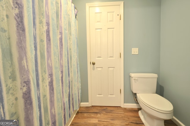 2025 Chicken Rd, Dudley, GA 31022 - full bathroom with wood finished floors, toilet, and baseboards