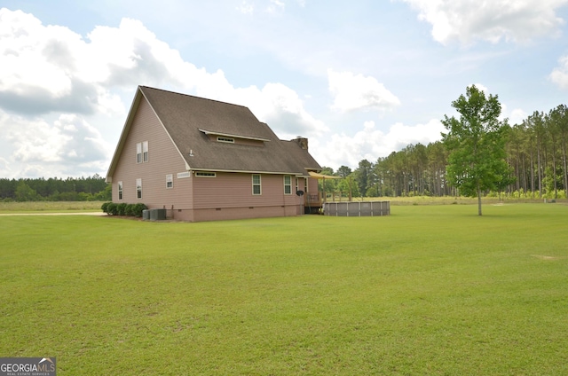 2025 Chicken Rd, Dudley, GA 31022 - view of side of home featuring central air condition unit, a lawn, a chimney, and a wooden deck
