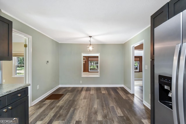 1069 Shellman Hammock Dr NE, Townsend, GA 31331 - unfurnished dining area with ornamental molding, dark wood finished floors, and baseboards