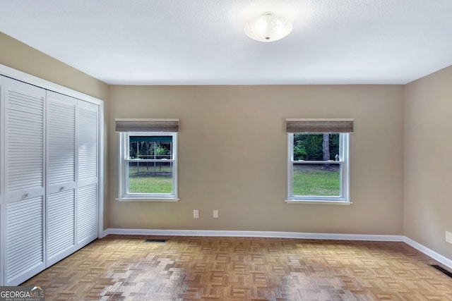 1069 Shellman Hammock Dr NE, Townsend, GA 31331 - unfurnished bedroom featuring multiple windows, a closet, and baseboards