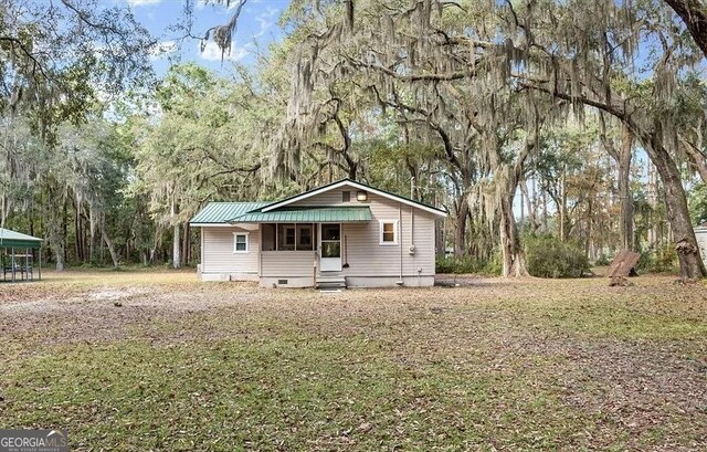 1069 Shellman Hammock Dr NE, Townsend, GA 31331 - view of front of home with crawl space, a metal roof, and entry steps