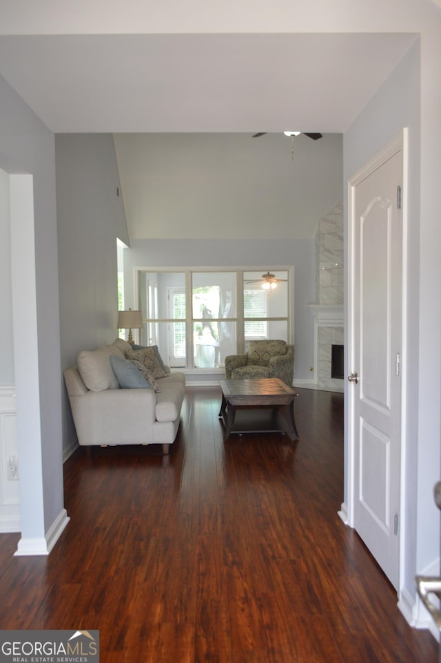 5427 Woodstream Ct, Gainesville, GA 30507 - living area featuring vaulted ceiling, a ceiling fan, wood finished floors, a large fireplace, and baseboards