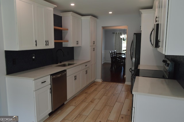 5427 Woodstream Ct, Gainesville, GA 30507 - kitchen with stainless steel appliances, a sink, open shelves, backsplash, and white cabinets