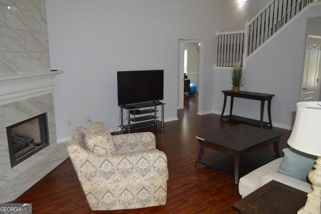 5427 Woodstream Ct, Gainesville, GA 30507 - living area featuring wood finished floors, stairway, a premium fireplace, baseboards, and a towering ceiling
