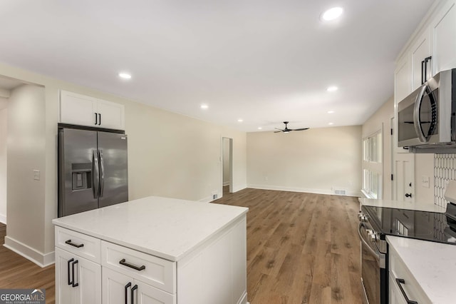 1364 Willis Mill Rd SW, Atlanta, GA 30311 - kitchen featuring appliances with stainless steel finishes, ceiling fan, white cabinets, and recessed lighting
