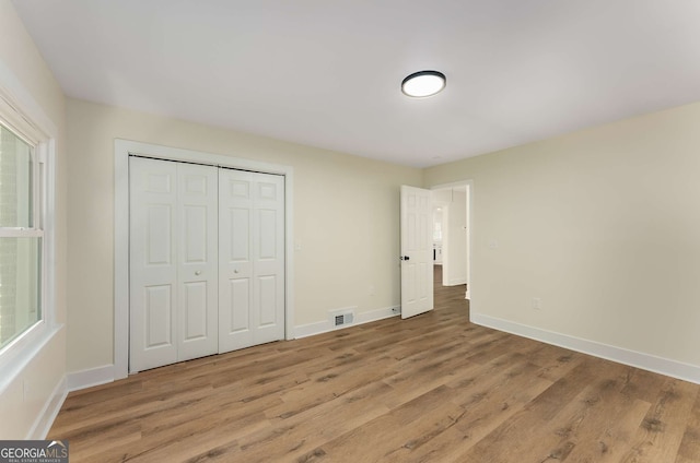 1364 Willis Mill Rd SW, Atlanta, GA 30311 - unfurnished bedroom with light wood-type flooring, baseboards, and a closet