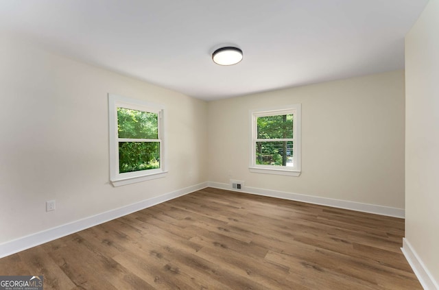 1364 Willis Mill Rd SW, Atlanta, GA 30311 - empty room featuring healthy amount of natural light, wood finished floors, and baseboards