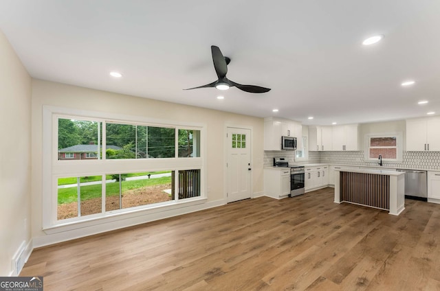 1364 Willis Mill Rd SW, Atlanta, GA 30311 - kitchen with stainless steel appliances, backsplash, white cabinetry, light countertops, and ceiling fan