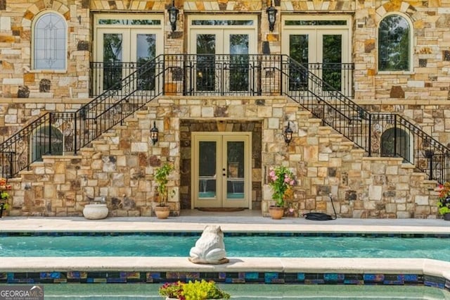 37 Retreat Rdg, Cartersville, GA 30120 - entrance to property with french doors, stone siding, and an outdoor pool