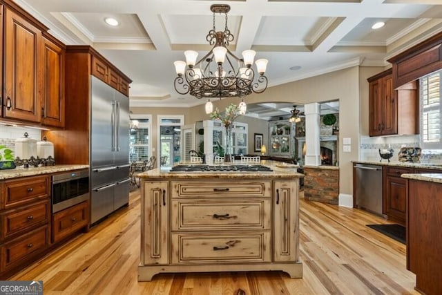 37 Retreat Rdg, Cartersville, GA 30120 - kitchen with stainless steel appliances, a chandelier, light wood-style flooring, light stone countertops, and crown molding