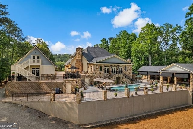 37 Retreat Rdg, Cartersville, GA 30120 - rear view of house with stairs, a fenced backyard, a chimney, and a patio