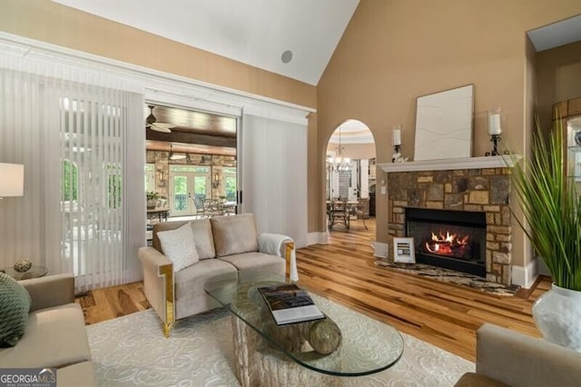 37 Retreat Rdg, Cartersville, GA 30120 - living room with wood finished floors, a stone fireplace, a ceiling fan, and high vaulted ceiling
