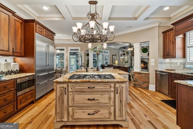 37 Retreat Rdg, Cartersville, GA 30120 - kitchen featuring appliances with stainless steel finishes, coffered ceiling, light wood-type flooring, a chandelier, and crown molding