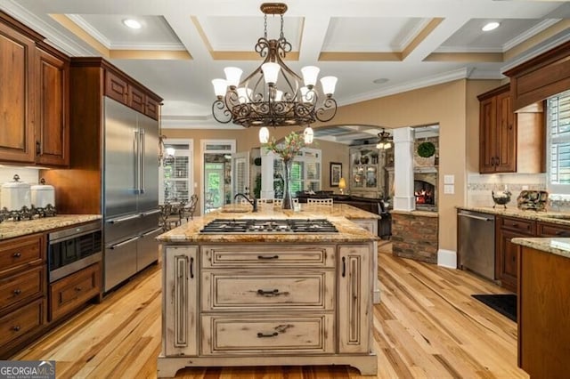 37 Retreat Rdg, Cartersville, GA 30120 - kitchen featuring appliances with stainless steel finishes, light wood finished floors, ornamental molding, open floor plan, and coffered ceiling