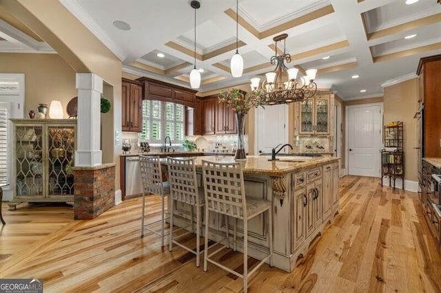 37 Retreat Rdg, Cartersville, GA 30120 - kitchen featuring ornamental molding, ornate columns, coffered ceiling, light wood-style flooring, and a breakfast bar area