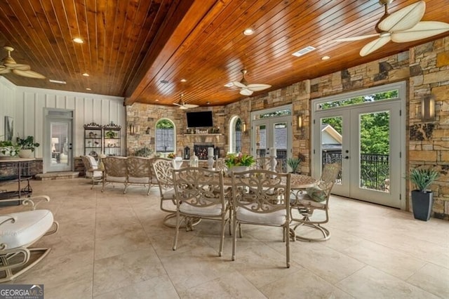 37 Retreat Rdg, Cartersville, GA 30120 - dining room with a ceiling fan, wood ceiling, french doors, a stone fireplace, and tile patterned flooring