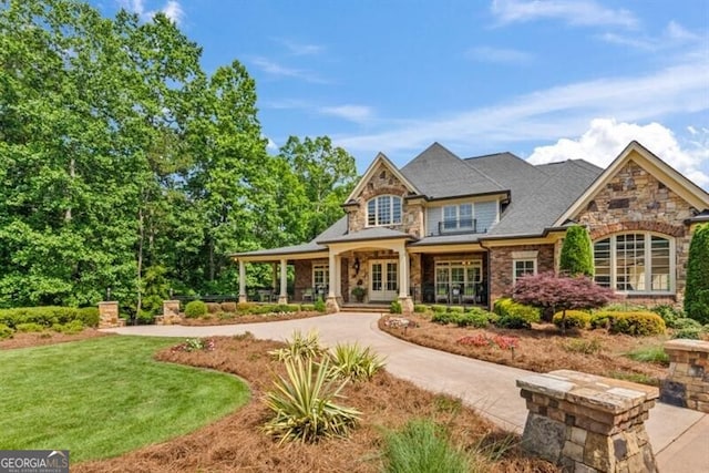 37 Retreat Rdg, Cartersville, GA 30120 - view of front facade with stone siding, covered porch, and a front lawn