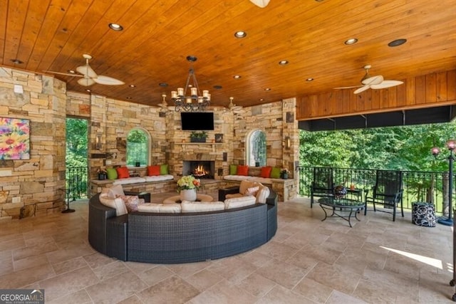 37 Retreat Rdg, Cartersville, GA 30120 - sunken living room with wood ceiling, ceiling fan, an outdoor stone fireplace, stone finish floors, and recessed lighting