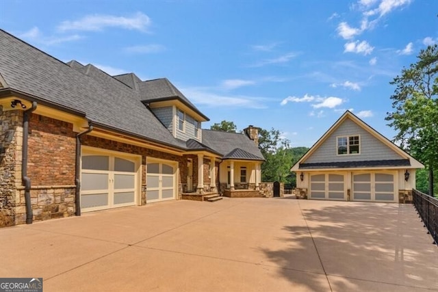 37 Retreat Rdg, Cartersville, GA 30120 - view of front of property featuring stone siding, a porch, concrete driveway, and a chimney